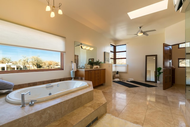 927 Camino Vista Rio, Bernalillo, NM 87004 - bathroom featuring a jetted tub, a skylight, vanity, and a ceiling fan