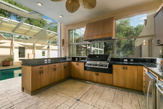 927 Camino Vista Rio, Bernalillo, NM 87004 - kitchen featuring premium range hood, stone tile floors, refrigerator, a peninsula, and recessed lighting