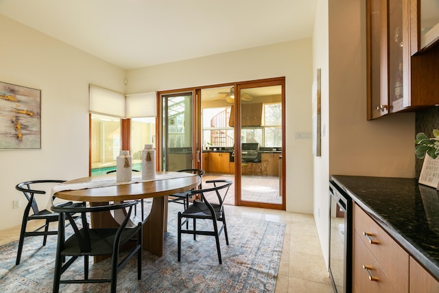 dining area featuring a healthy amount of sunlight, light tile patterned floors, and wine cooler