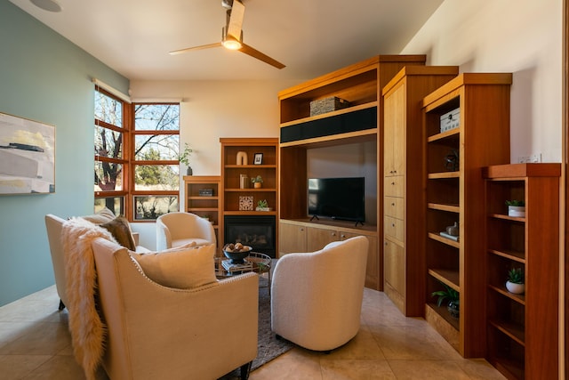 living area featuring a ceiling fan and light tile patterned floors