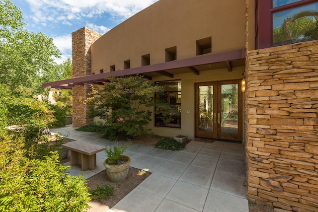 927 Camino Vista Rio, Bernalillo, NM 87004 - doorway to property featuring french doors, stucco siding, and stone siding
