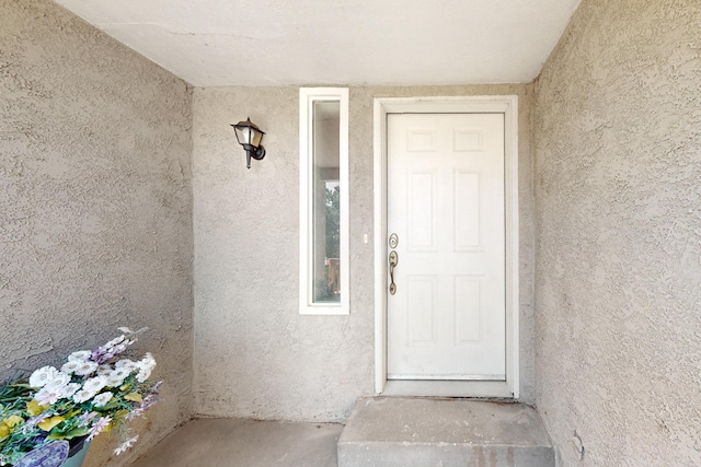 doorway to property with stucco siding