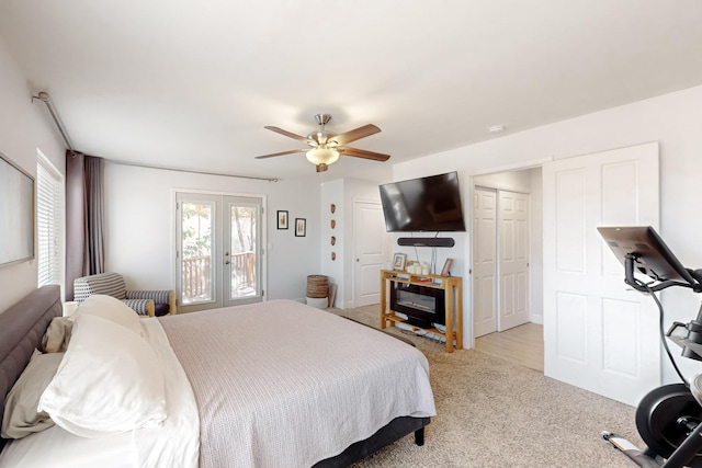 carpeted bedroom with french doors and a ceiling fan