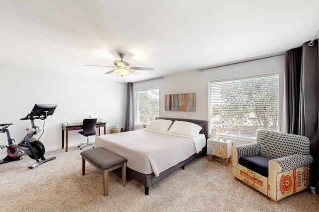 bedroom with light carpet, ceiling fan, and baseboards