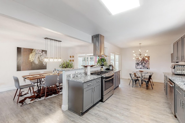 kitchen with light wood-style flooring, island exhaust hood, appliances with stainless steel finishes, and gray cabinets