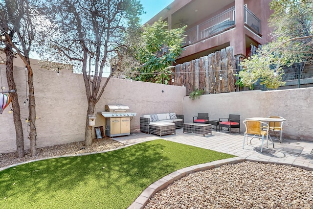 view of yard featuring a fenced backyard, a patio, and an outdoor hangout area