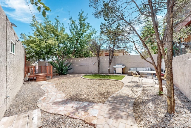 view of yard featuring a fenced backyard, a patio, and a deck