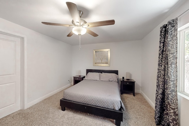 carpeted bedroom featuring a ceiling fan and baseboards