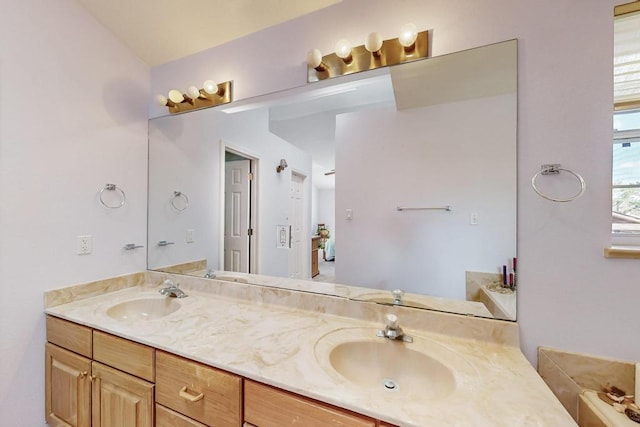 full bathroom featuring double vanity and a sink