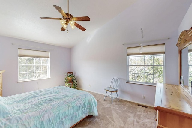 bedroom with visible vents, carpet floors, multiple windows, and vaulted ceiling