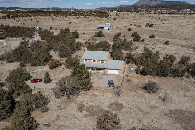 aerial view featuring a mountain view and a desert view