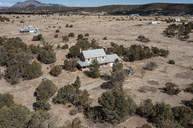 birds eye view of property with view of desert, a rural view, and a mountain view