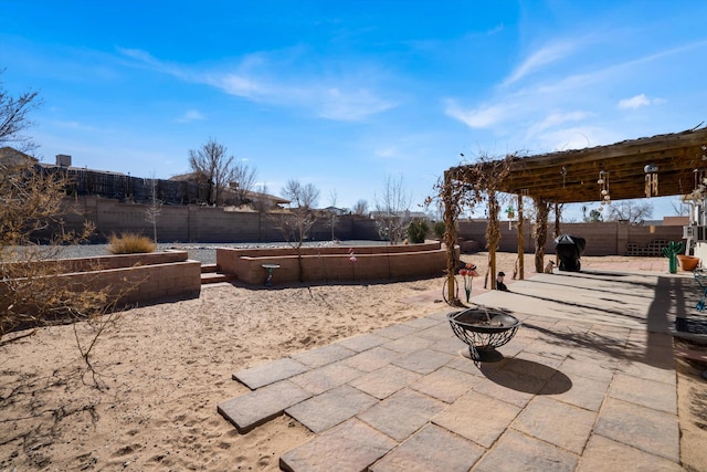 view of patio with an outdoor fire pit, a fenced backyard, and a vegetable garden