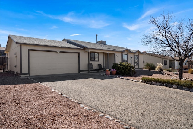 ranch-style home featuring an attached garage and driveway