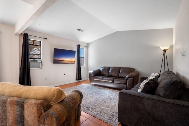 living area featuring light tile patterned floors, lofted ceiling, visible vents, cooling unit, and baseboards