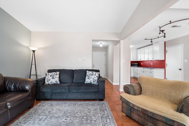 living area featuring visible vents, baseboards, and light tile patterned floors