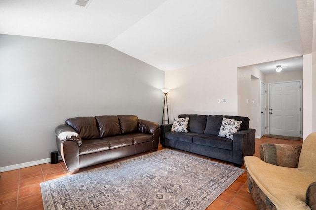 living area featuring tile patterned flooring, baseboards, and vaulted ceiling