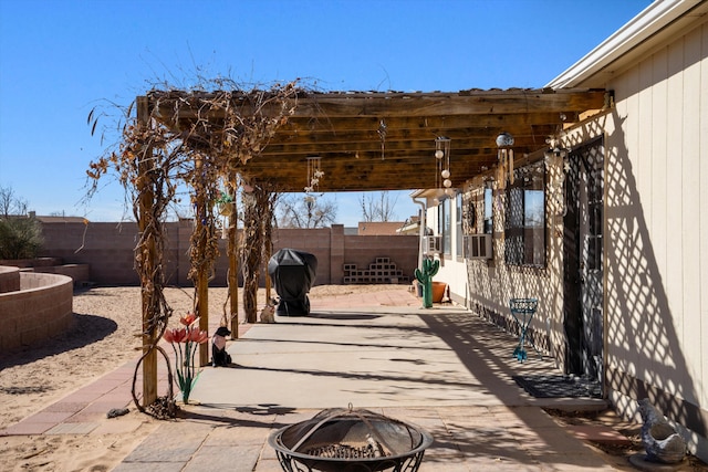 view of patio featuring a fire pit, cooling unit, a fenced backyard, and a grill