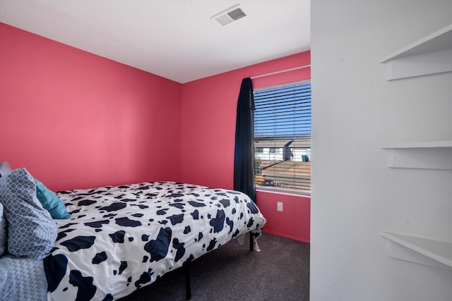 carpeted bedroom featuring visible vents