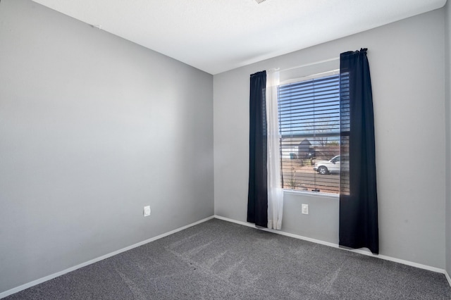 empty room with carpet floors and baseboards