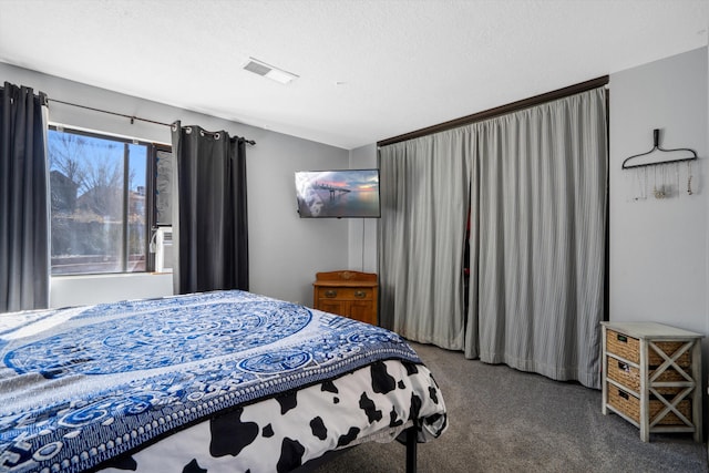 carpeted bedroom featuring visible vents and a textured ceiling