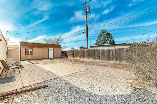 view of yard featuring a patio area, an outdoor structure, and a fenced backyard