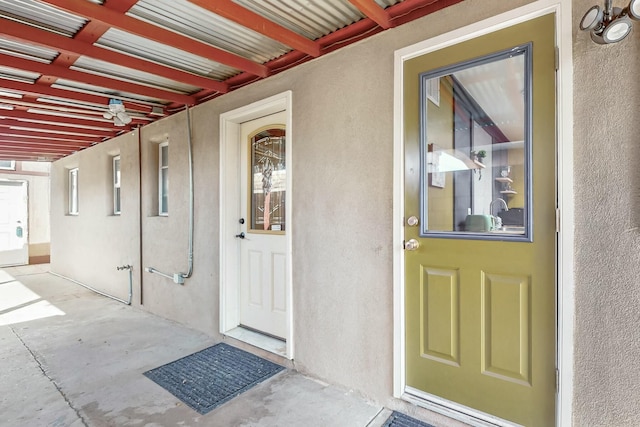 entrance to property featuring stucco siding