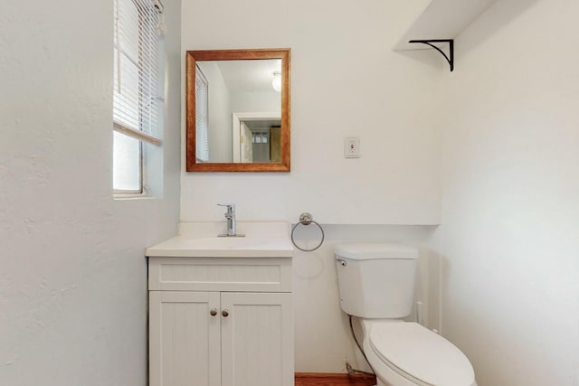 bathroom featuring toilet and vanity