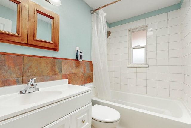 bathroom featuring toilet, shower / bath combo, tile walls, and vanity