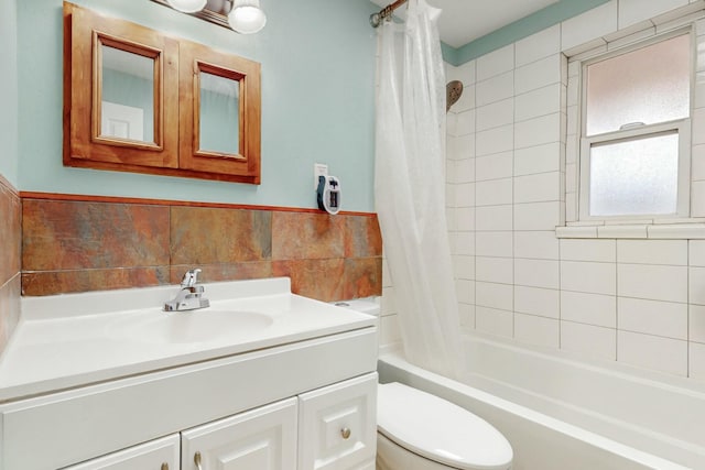 bathroom with shower / bath combo, vanity, and toilet