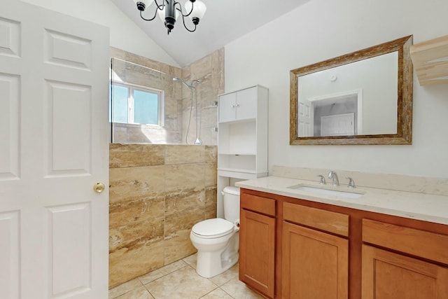 bathroom with lofted ceiling, tile patterned flooring, toilet, vanity, and a tile shower