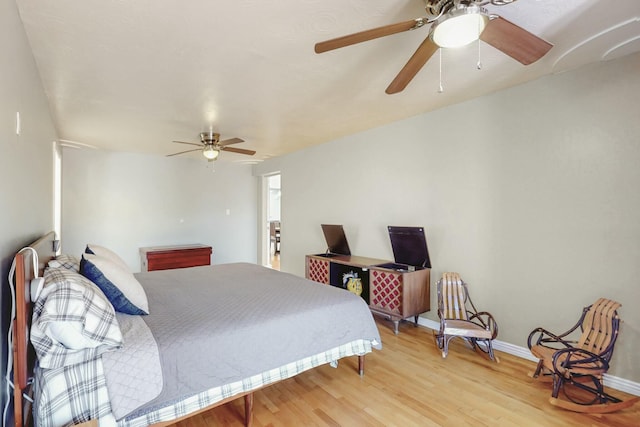 bedroom featuring light wood-type flooring, ceiling fan, and baseboards