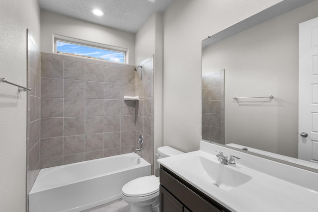 full bath featuring toilet, a textured ceiling, tile patterned flooring, shower / bath combination, and vanity