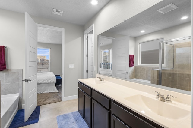 bathroom with a textured ceiling, visible vents, and a sink