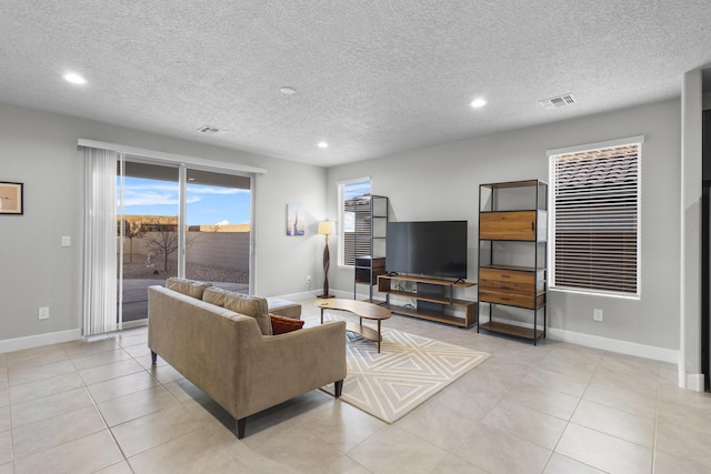 living area with recessed lighting, visible vents, baseboards, and light tile patterned floors