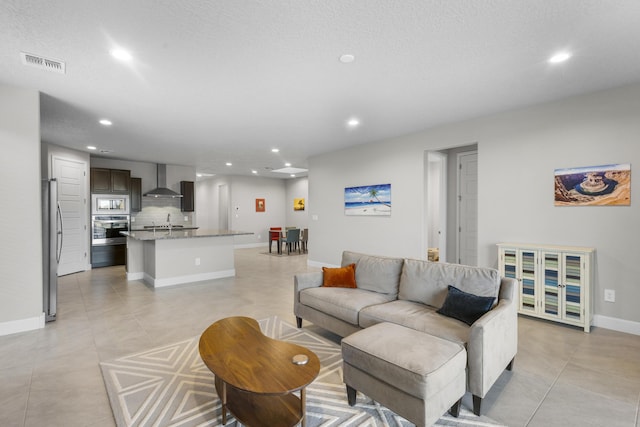 living room featuring recessed lighting, visible vents, baseboards, and light tile patterned flooring