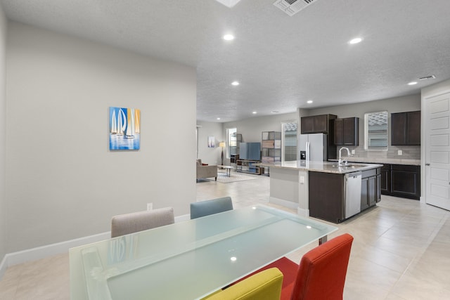 dining area with baseboards, recessed lighting, visible vents, and a textured ceiling