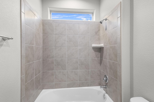 bathroom with toilet and  shower combination