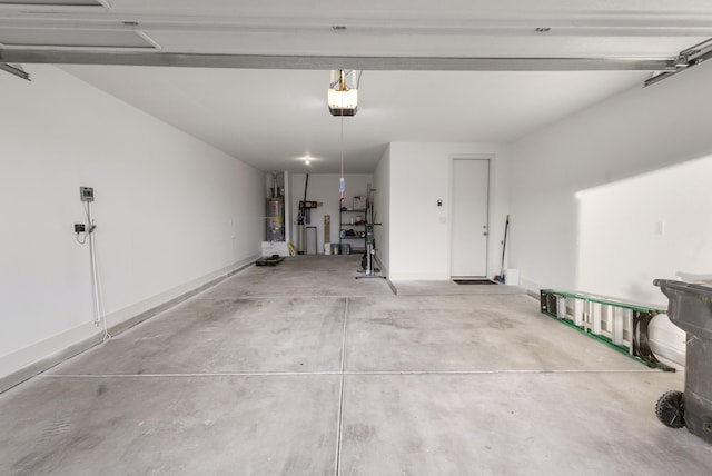 garage with baseboards, a garage door opener, and water heater