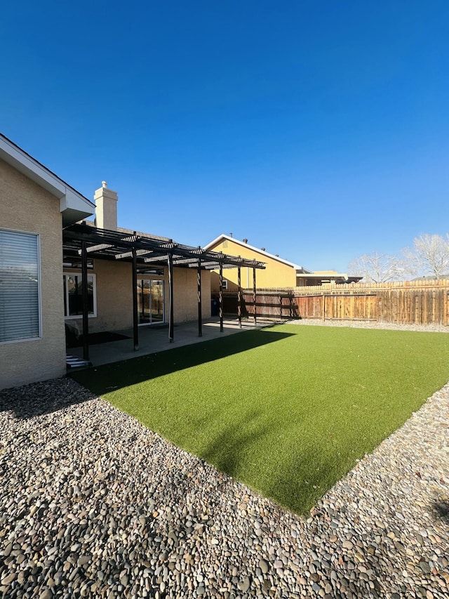 view of yard with a patio area, fence, and a pergola