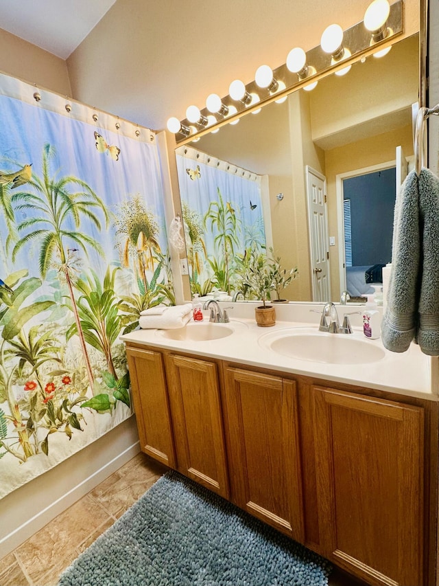 bathroom with double vanity, a shower with curtain, a sink, and tile patterned floors