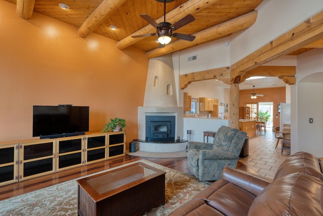 living room with visible vents, arched walkways, wooden ceiling, ceiling fan, and beam ceiling