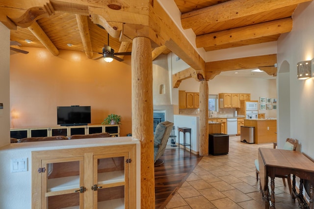 dining room featuring arched walkways, a fireplace, ceiling fan, wooden ceiling, and beamed ceiling