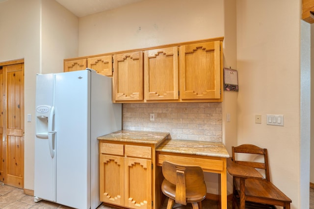 kitchen with white fridge with ice dispenser and decorative backsplash