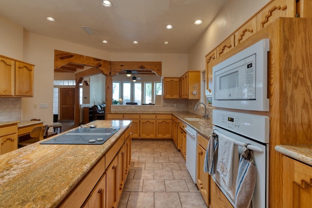 kitchen with white appliances, recessed lighting, a sink, and decorative backsplash