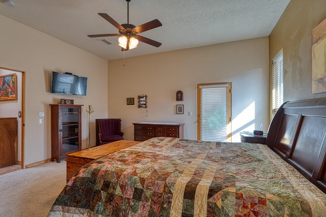 bedroom featuring light colored carpet, visible vents, ceiling fan, a textured ceiling, and baseboards