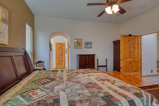 bedroom with arched walkways and ceiling fan