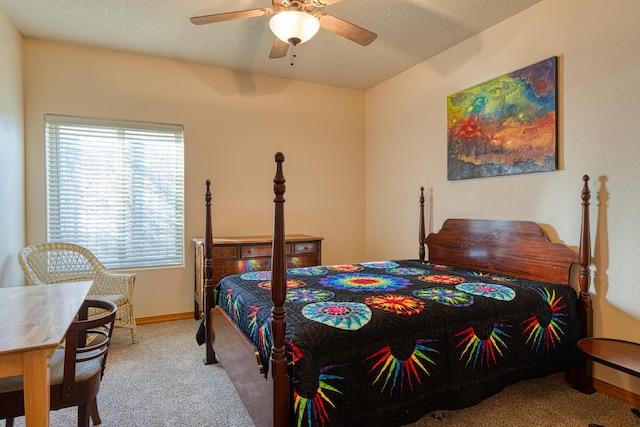 bedroom featuring carpet floors, a textured ceiling, baseboards, and a ceiling fan