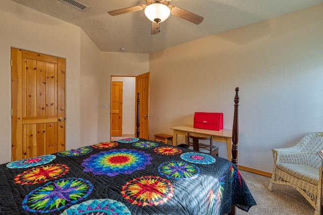 bedroom featuring carpet floors, visible vents, ceiling fan, a textured ceiling, and baseboards