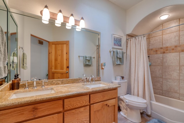 full bathroom featuring shower / bath combination with curtain, a sink, toilet, and double vanity